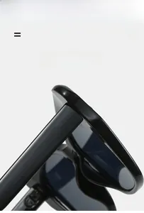 Detailed close-up of high-gloss black sunglasses hinge showing light and super elastic frame