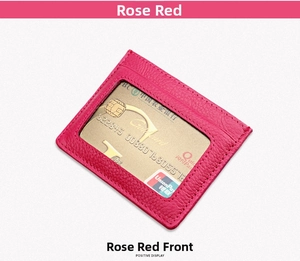 Detail of rose red litchi texture leather card holder with a clear ID slot for credit cards