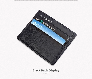Macro shot of black pebbled leather card holder showing multiple slots and stitching
