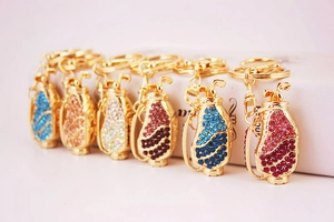 Macro shot of colorful rhinestone golf bag keychains in gold metal finish