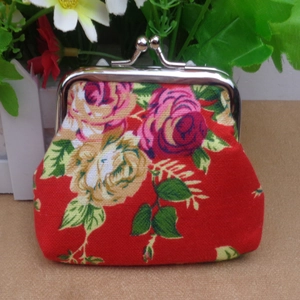 Detail of red floral canvas coin purse with vintage kiss-lock metal clasp design