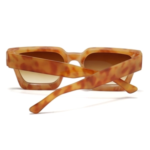 Detail of chunky tortoise shell square sunglasses with thick frames and gradient lenses