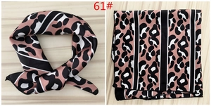 Detail view of pink and black leopard print satin scarf shown tied and folded flat