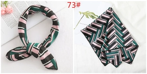 Detailed close-up of geometric pattern silk scarf styled as a neckerchief for women