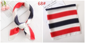 Detail view of a red, white and blue striped square silk scarf with bow-tied styling