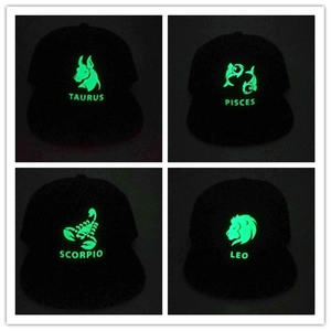 Luminous Zodiac signs on black baseball caps featuring glowing Taurus Pisces Scorpio and Leo
