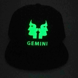 Luminous Gemini zodiac glowing baseball cap showing neon green print in dark environment