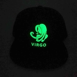 Luminous Virgo constellation design on a black hip hop cap glowing in green light