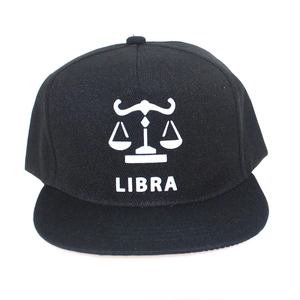 Detail of Libra constellation logo and text on black flat brim snapback cap fabric