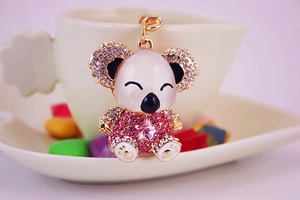 Close-up of pink rhinestone koala keychain with gold metal and star-shaped crystal detail