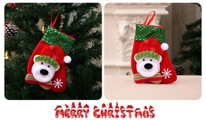 Detail of red Christmas stocking with white 3D polar bear and green sequin cuff