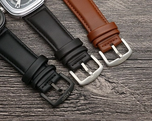 Detail of leather watch straps in black and brown with stainless steel buckles