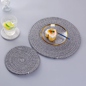 Close-up of grey hand-woven cotton heat resistant coasters and placemats on dining table