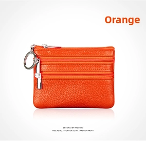 Orange genuine leather coin purse with triple zipper pockets and a metal keychain ring