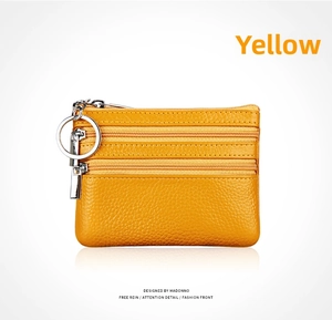 Detailed view of yellow lychee texture leather coin purse with three zipper compartments