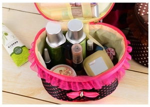 Close-up of interior of pink lace polka dot makeup bag with cosmetics