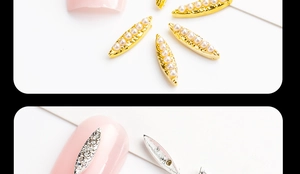 Macro shot of leaf-shaped alloy nail charms with pearls and rhinestones on nails