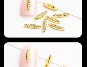 Macro detail of marquise nail charms with white rhinestones and pearls on gold alloy