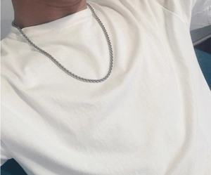 Detailed view of silver stainless steel keel link chain necklace worn on male neck