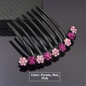 Detail of wave hair comb with sparkling purple red pink rhinestone flowers