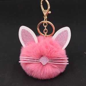 Close-up of pink fluffy cat keychain with glitter ears and golden metal lobster clasp