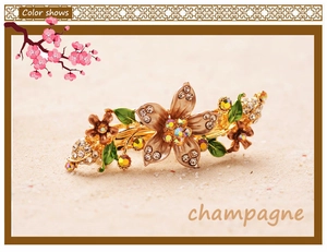 Detail of champagne floral hair clip with enamel flowers and sparkling rhinestones
