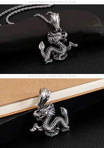 Macro shot of stainless steel dragon pendant and twist chain on stone base