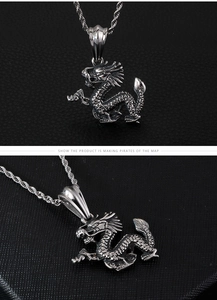 Detailed view of silver dragon pendant showing intricate carvings and vintage twist chain