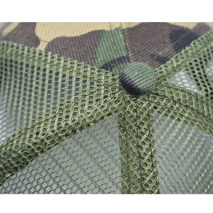 Close-up of camouflage trucker hat crown with green mesh and top button detail