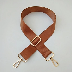 Detail of adjustable brown nylon shoulder strap with gold-tone metal lobster clasps