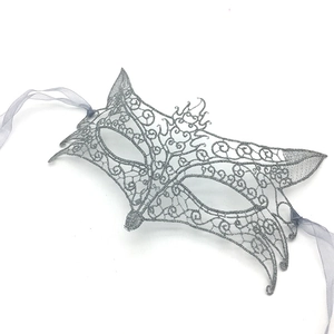 Detailed view of silver grey lace fox mask with silk ribbons for masquerade parties