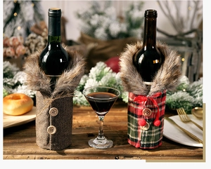 Close-up of festive wine bottle covers with faux fur collars and wooden buttons