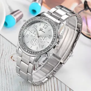 Macro detail of silver Geneva watch with rhinestone bezel and polished metal steel band