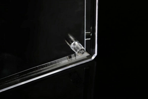 Macro shot of polished clear acrylic glasses display stand with cylindrical support legs