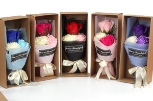 Detail view of five assorted soap flower bouquets in kraft gift boxes with ribbons