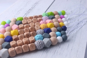 Detailed view of pacifier clips with beech wood and colorful silicone baby beads