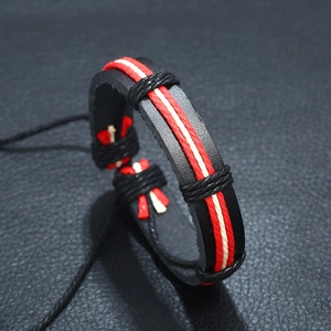 Macro shot of braided black leather bracelet with red and white rope detail and adjustable cord