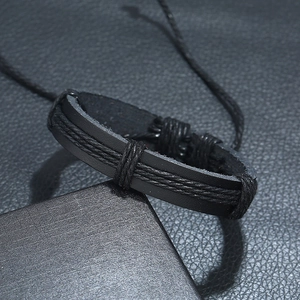 Detail view of black woven leather bracelet showing braided rope texture and punk style