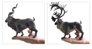 Detailed view of hand-held realistic mountain goat and caribou wildlife animal figures