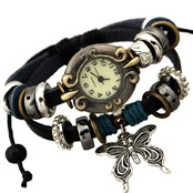 Detail of vintage bronze quartz watch with leather layers and a butterfly charm pendant