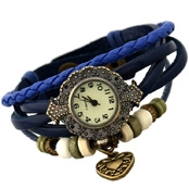 Detail view of a vintage bronze watch bracelet with blue leather straps and heart charm