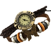 Detail of vintage bronze watch with woven leather straps and butterfly charm on white background