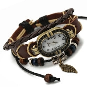 Close-up of brown woven leather watch bracelet with quartz movement and bronze leaf charm