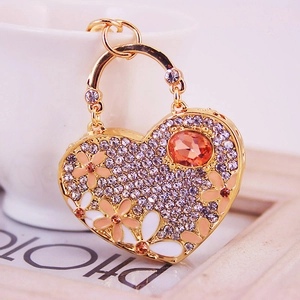 Charming heart keychain with orange gemstone and enamel flowers on a gold-plated frame