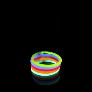 Macro display of assorted colorful glow stick bracelets shining in the dark