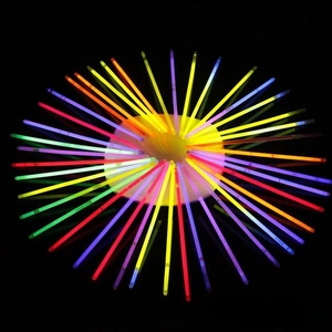 Macro display of assorted neon glow sticks in various colors against a dark background