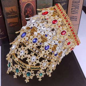 Detailed close-up of Baroque crowns with colorful rhinestones on vintage books