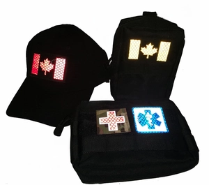 Close-up of tactical cap and bags with reflective IR infrared patches and flag markers