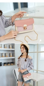 Detail of pink and beige mini shoulder bag featuring star sequins and a gold chain strap