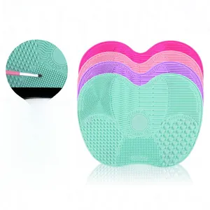 Detail of heart silicone makeup brush cleaning mat with textured surface and suction cups
